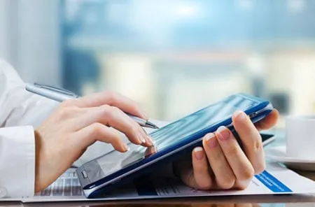 person using a tablet for patient registration
