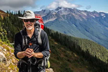 man out hiking on a ridgetop